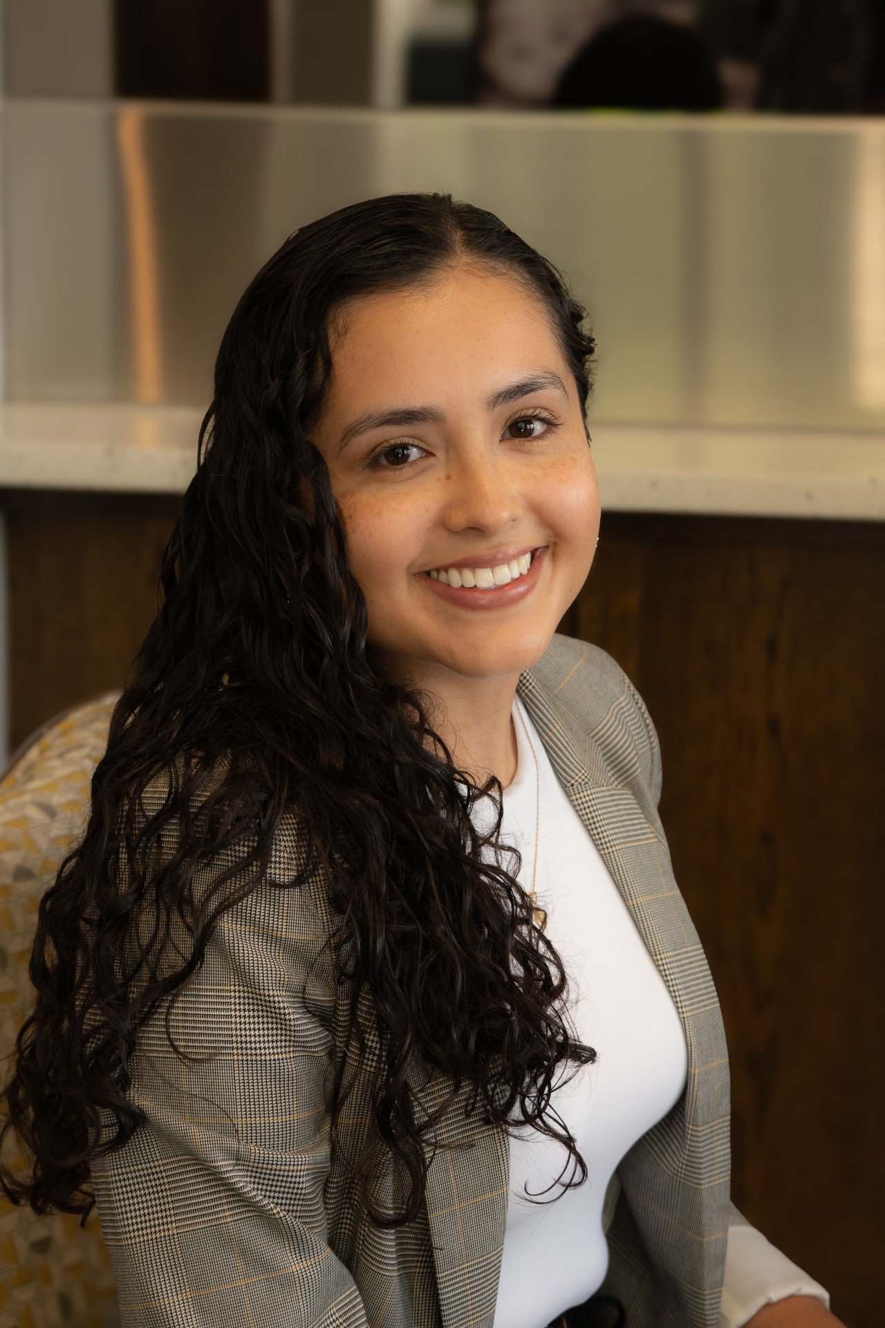 Mariana Franco, SHRM-certified career coach, working at her desk